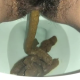 A very cute girl shits a long hanging log into the toilet from under ass late in the clip, with product in the bowl. Filmed from a between the legs perspective. Vertical format video. Over a minute.